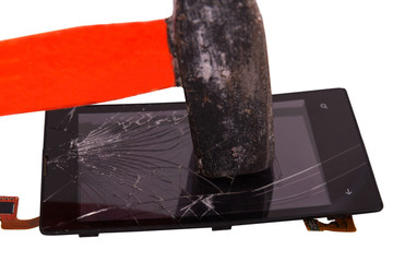 hammer blow on the display of the mobile phone, cracked on the touchscreen. hammer a high-tech device