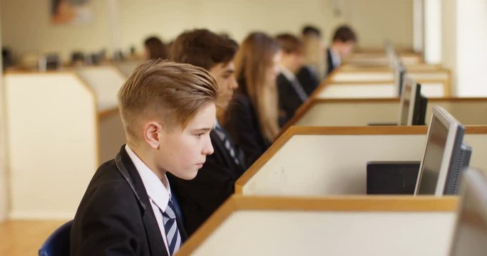 4k, Row of children working on computers at school.