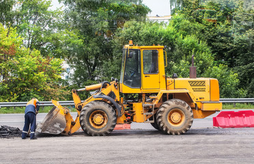 yellow forklift on road works