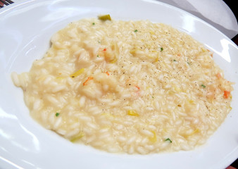 Seafood risotto on white plate