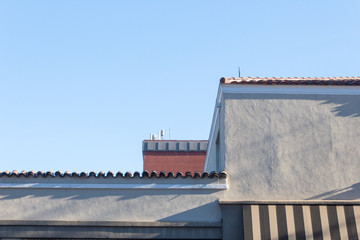 Generic roofline of building with stucco and tile roof, copy space, horizontal aspect