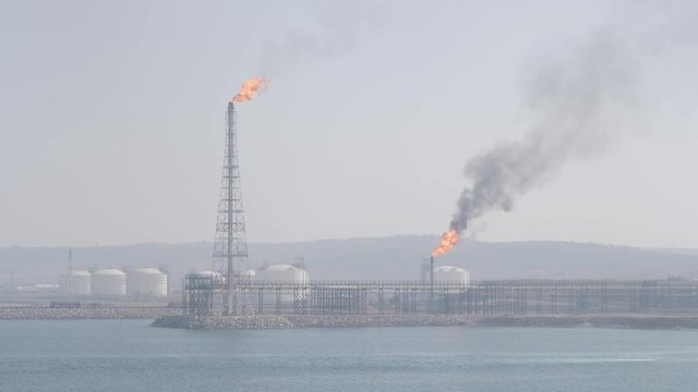 Petrochemical refiery on sea shore in haze
