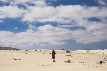 Alone man walking in the desert of Fuerteventura