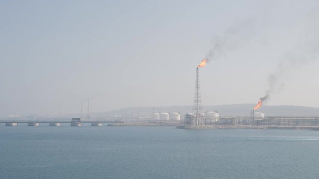 Flare stack of petrochemical refinery in port