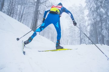 Zelfklevend Fotobehang A man cross-country skiing in front of winter landscape © kovop58