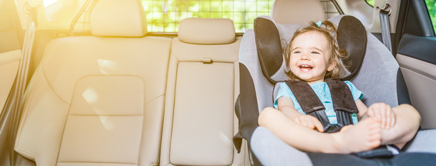 Infant baby girl buckled into her car seat. © REDPIXEL