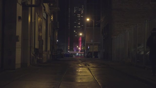 Dark winter alleyway with mysterious futuristic glowing building