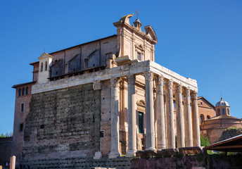 Fototapeta na wymiar Illuminated and shadowed parts of temple of Antonin and Faustine in Rome, Italy