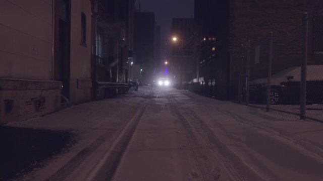 Headlights in the distance of a dark alleyway