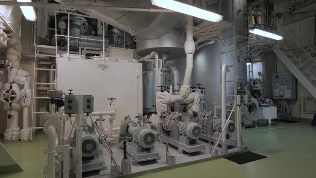 Steam boiler with hot well and pumps in engine room of ship
