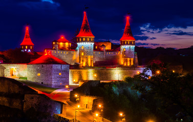 Fototapeta na wymiar Amazing evening view of the medieval castle fortress in Kamianets-Podilskyi, Ukraine.