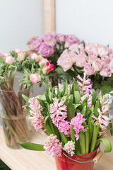 Flower shop concept. Different varieties fresh spring flowers in refrigerator room for flowers. Bouquets on shelf, florist business.