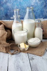 milk products. tasty healthy dairy products on a table on. sour cream in a bowl, cottage cheese bowl, cream in a a bank and milk jar, glass bottle and in a glass