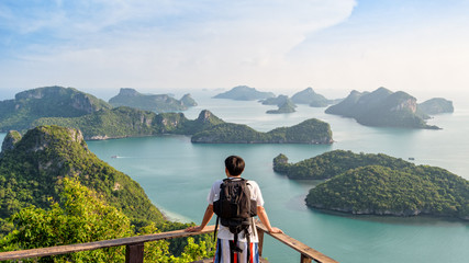 Backpack Asian man on the mountain see view panorama the beautiful nature landscape of the sea adventure on vacation travel leisure to Asia on Mu Ko Ang Thong island National Park background, Thailand - obrazy, fototapety, plakaty