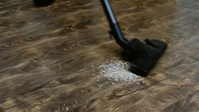 A Housewife Uses A Vacuum To Clean The Floor In Her Home