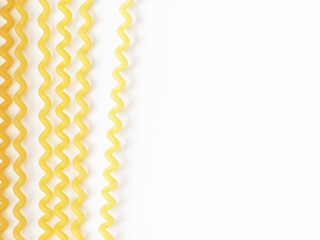 Long spaghetti fusilli isolated on the white background, pasta, macaroni, noodles. Traditional Italian food. Top view, close-up. Space for text © ANGHI
