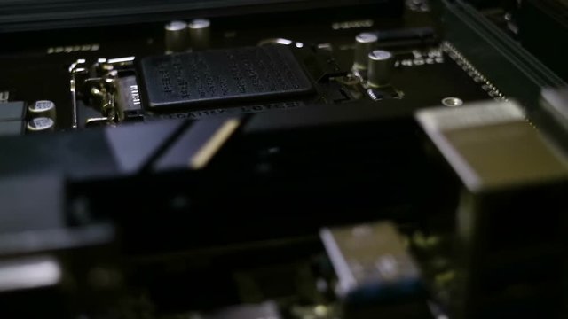 Big printed circuit board. Many electronic components such as capacitors, resistors, switches, radiators. Motherboard closeup. Glide view