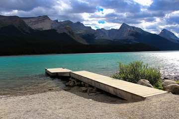 A dock beside a rocky mountain lake