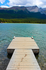 A dock beside a rocky mountain lake