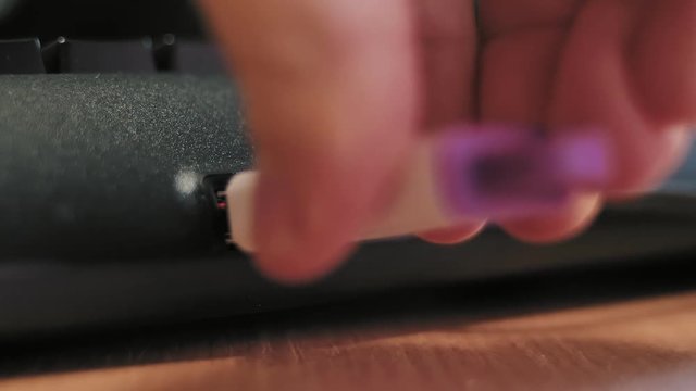 Inserting usb flash drive into computer keyboard and pull out. Closeup. Shallow depth of field.