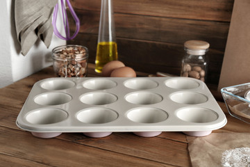 Baking form with ingredients for preparing pastries on table