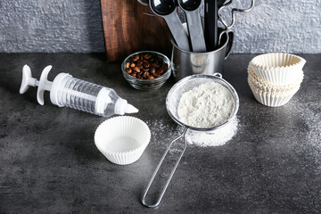 Fototapeta na wymiar Kitchen utensils and ingredients for preparing pastries on table