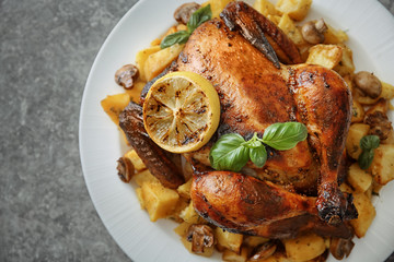 Yummy whole roasted chicken served on plate