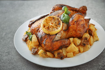 Yummy whole roasted chicken served on plate