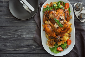 Delicious whole roasted chicken served on wooden table