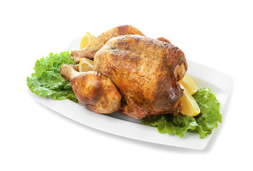 Plate with delicious whole roasted chicken on white background