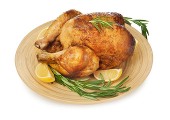 Plate with delicious whole roasted chicken on white background