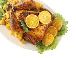 Plate with delicious whole roasted chicken on white background