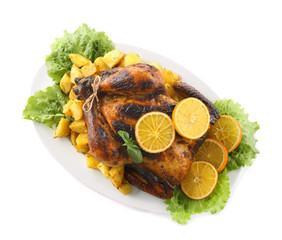 Plate with delicious whole roasted chicken on white background