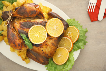 Delicious whole roasted chicken served on plate