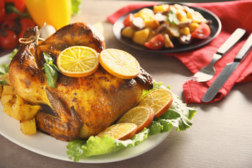 Delicious whole roasted chicken served on plate