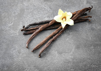 Vanilla sticks and flower on grey background