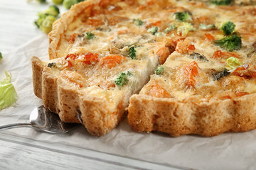 Tasty broccoli quiche on table, closeup