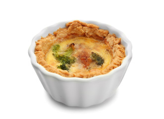 Ramekin with tasty broccoli quiche on white background