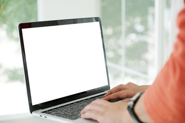 Man hands typing laptop computer with blank screen for mock up template background, business technology and lifestyle background concept