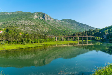The railway bridge passes over a mountain river.