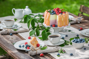 Sweet summer dessert with raspberries and blueberries served with coffee