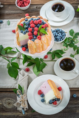 Sweet summer dessert with berries and biscuits served with coffee
