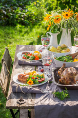 Homemade dinner with salad and chicken served in the countryside