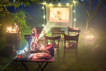 Small cinema with retro projector in the garden
