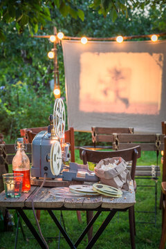 Open-air cinema with retro projector in the garden