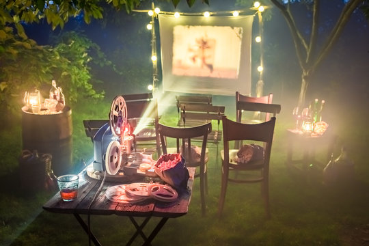 Small cinema with retro projector in the garden
