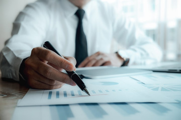 Business people meeting working with new startup project use post it notes to share idea discussion and analysis data charts and graphs.Business finances and accounting concept