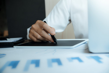 Fototapeta premium Close up hands male graphic designers,interior designer.Working on graphic tablet in modern space office.discuss data about new start up project of graphics design style and graphics design diagram