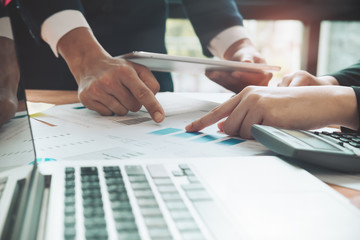 Business people meeting working with new startup hands project pointing graph discussion and analysis data charts and graphs.Business finances and accounting concept