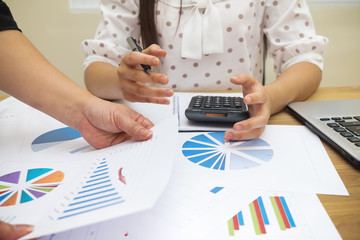 Business people meeting working with pointing graph discussion and analysis data charts and graphs.Business finances and accounting concept,stacks of coins,Saving money concept